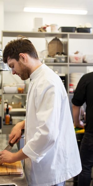 chef-and-cook-cooking-food-at-restaurant-kitchen.jpg